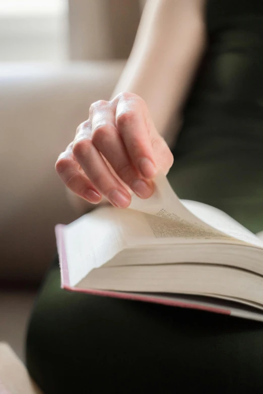 a woman sitting on the floor reading a book, by Julian Allen, diary on her hand, zoomed in, closeup shot, purity