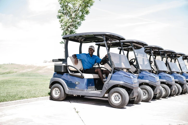 a man riding on the back of a blue golf cart, a portrait, unsplash, jemal shabazz, colorado, avatar image, high resolution photo