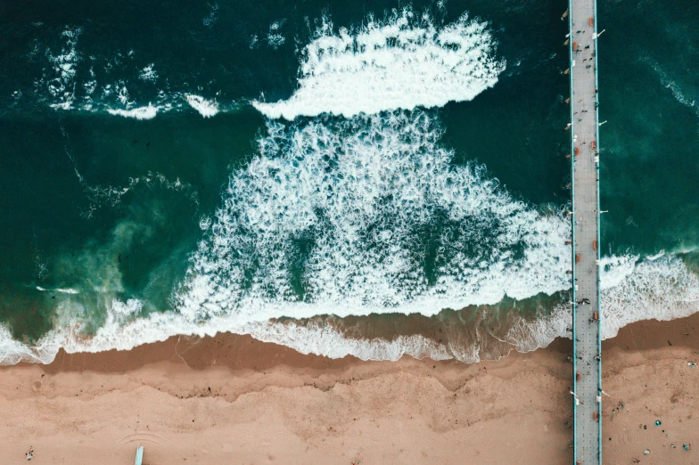 a couple of surfboards sitting on top of a sandy beach, an album cover, pexels contest winner, minimalism, helicopter view, boardwalk, large waves crashing over it, manly