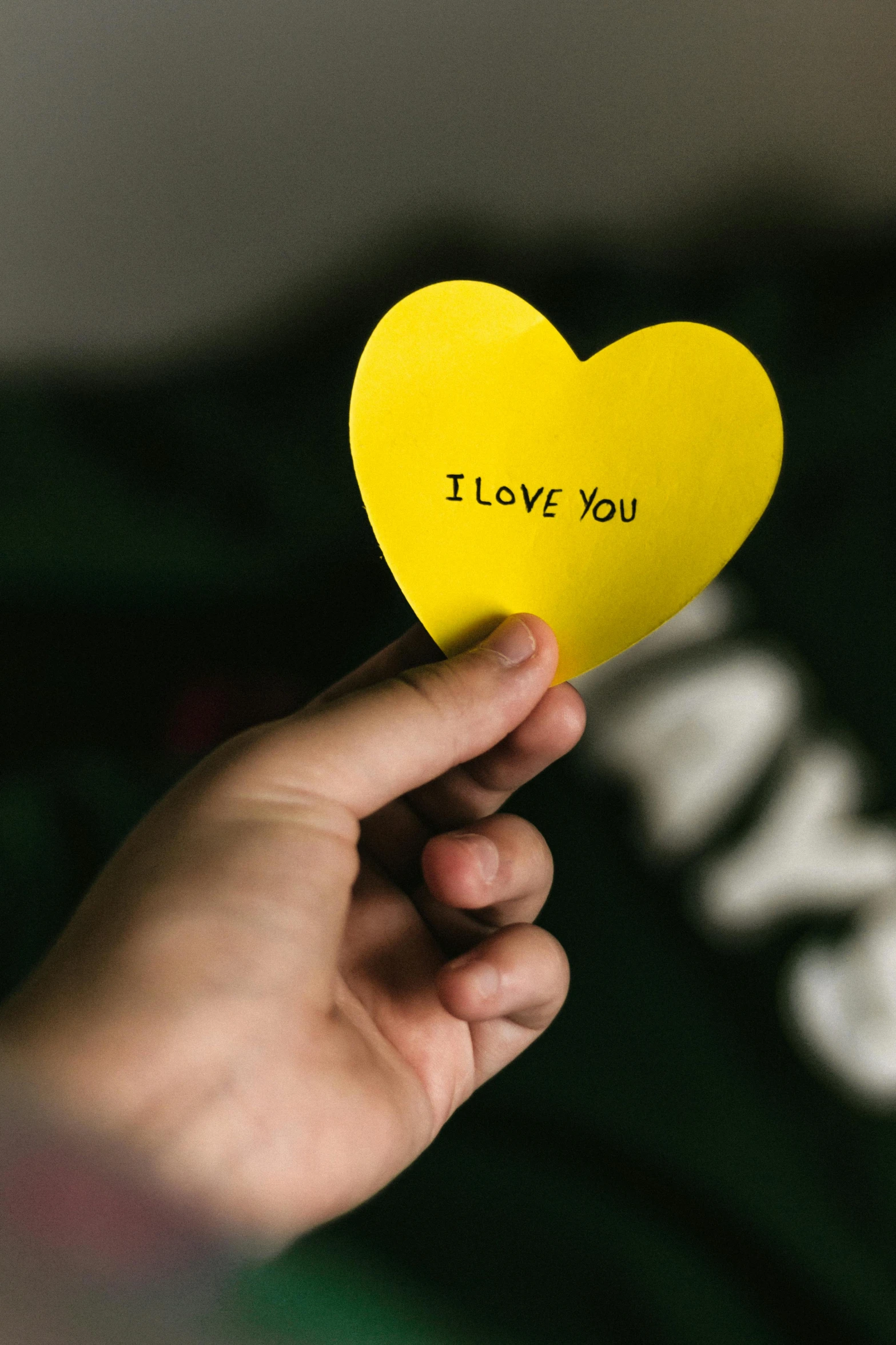 a person holding a yellow paper heart that says i love you, pexels, instagram post, digital image, label, greg rutwoski