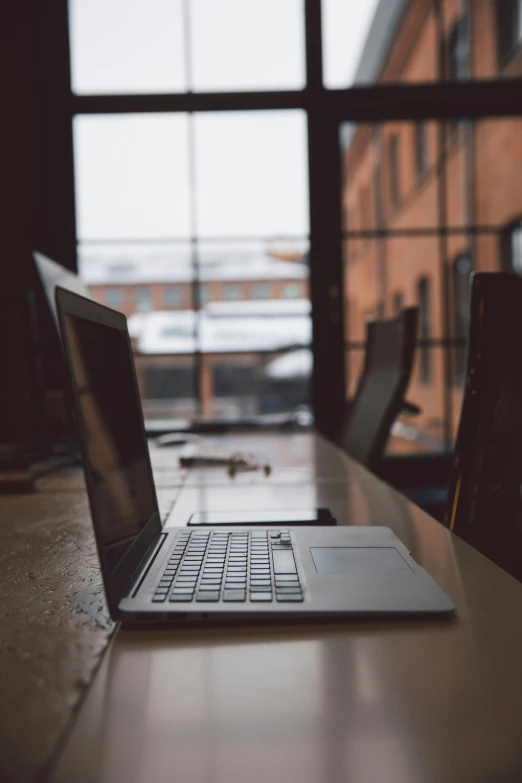 a laptop computer sitting on top of a wooden table, by Carey Morris, unsplash, multiple stories, recognizable, the