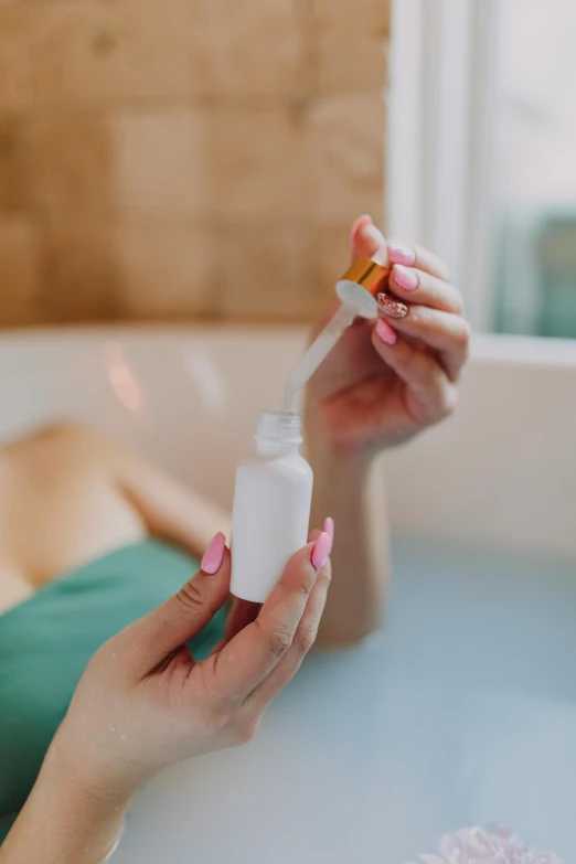 a woman taking a bath in a bathtub, pexels, process art, holding a bottle of arak, candy treatments, small in size, detailed product image