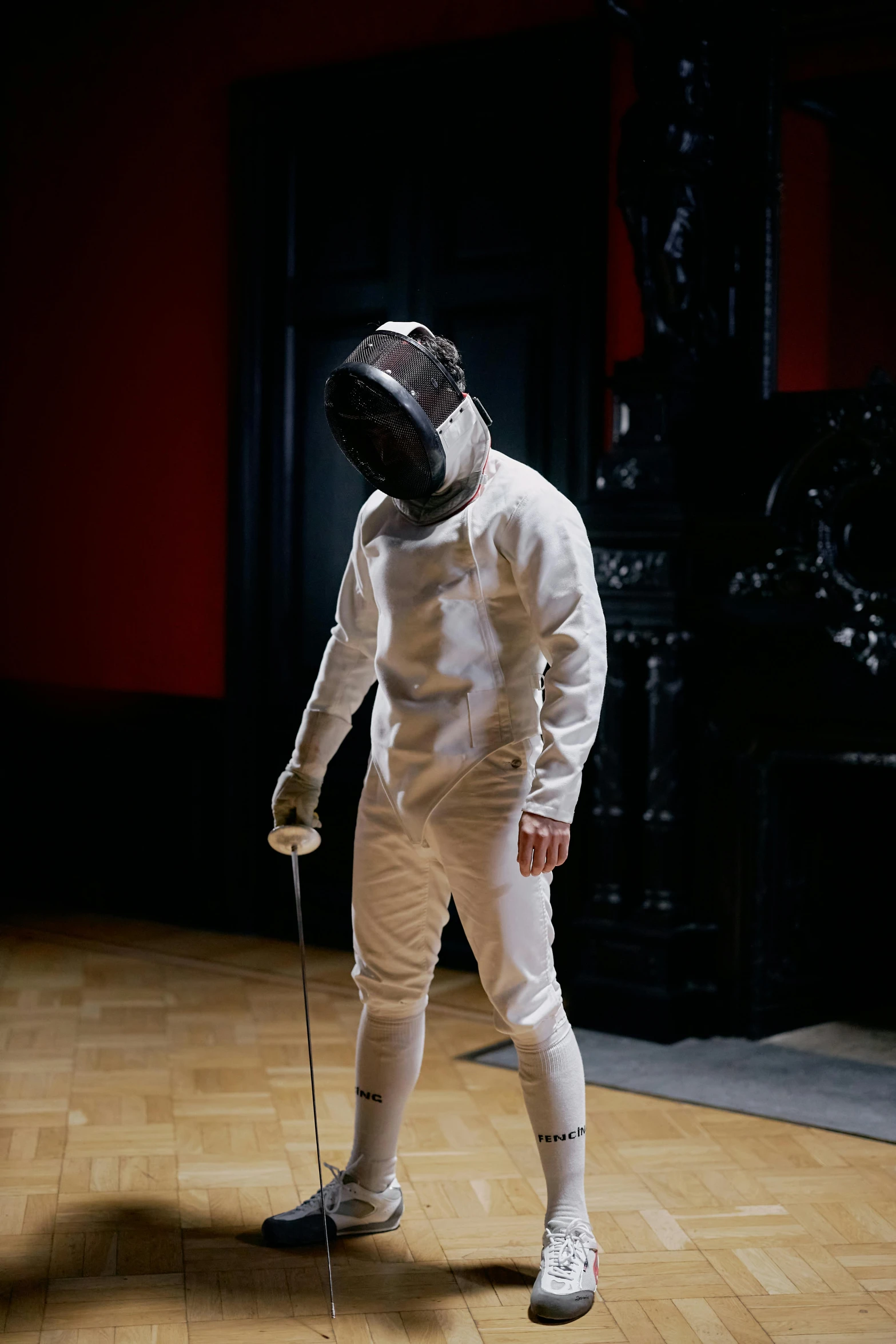 a man in a fencing suit standing on a wooden floor, instagram picture, helmet is off, ignant, hammershøi