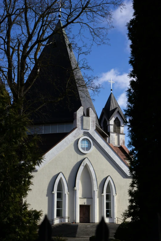 a church with a clock on the front of it, by Harry Haenigsen, romanesque, nice spring afternoon lighting, ribbon chapel, napa, view from the street