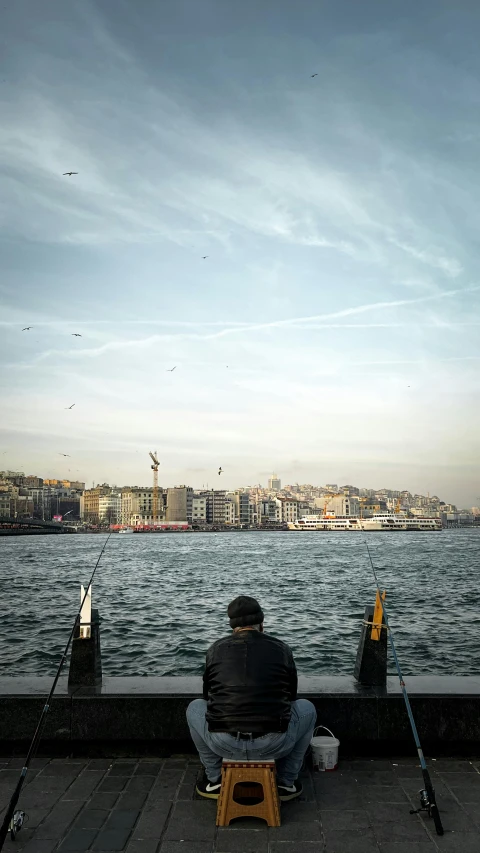 a man sitting on a dock next to a body of water, by Tobias Stimmer, pexels contest winner, happening, fallout style istanbul, panorama, fisherman, three views