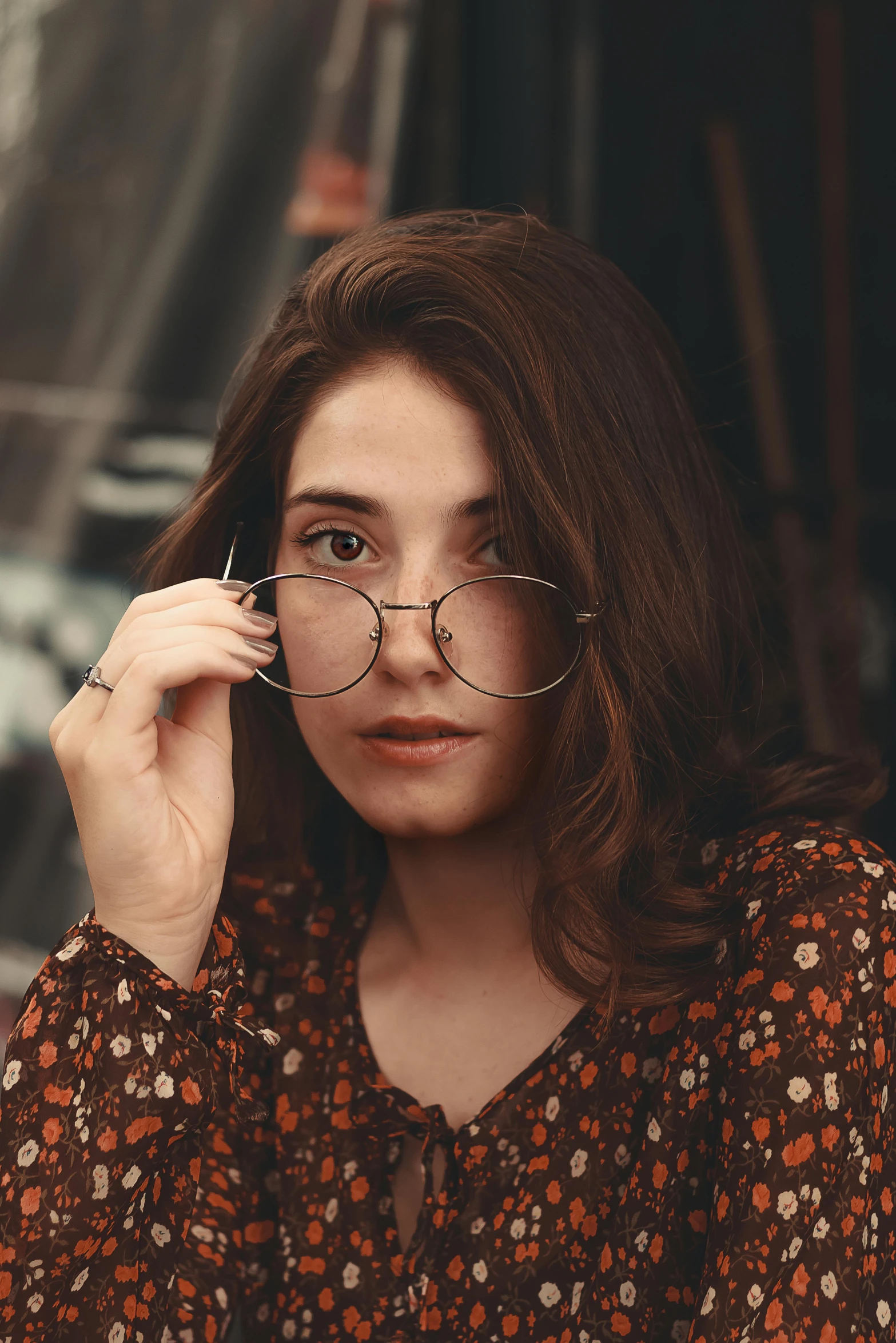 a woman with glasses sitting at a table, a picture, trending on pexels, girl with dark brown hair, retro stylised, 🤤 girl portrait, student