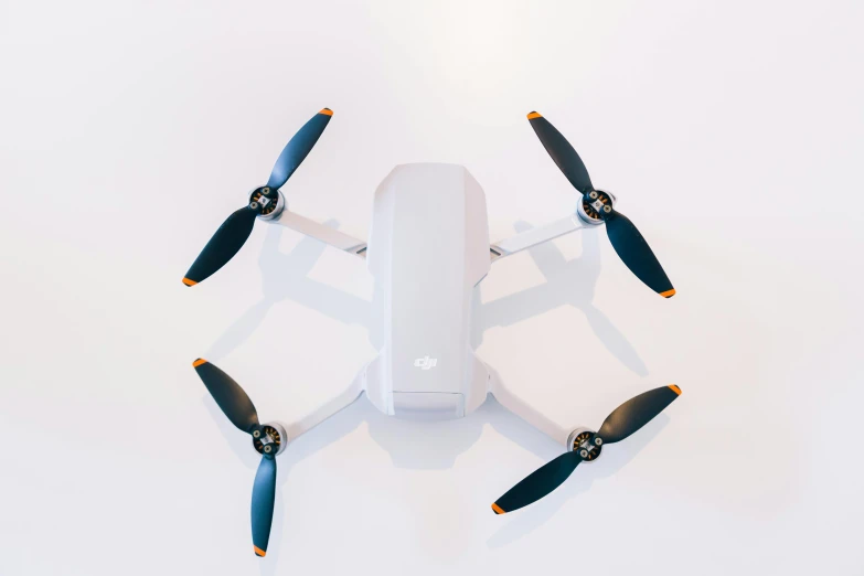 a white drone sitting on top of a white surface, unsplash, hurufiyya, 🦩🪐🐞👩🏻🦳, with accurate features, white and orange, tabletop model