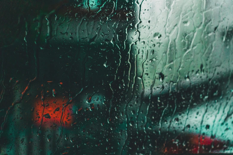 a close up of a window with rain on it, an album cover, inspired by Elsa Bleda, pexels contest winner, blue and green and red tones, inside of a car, depressive vibe, chillhop