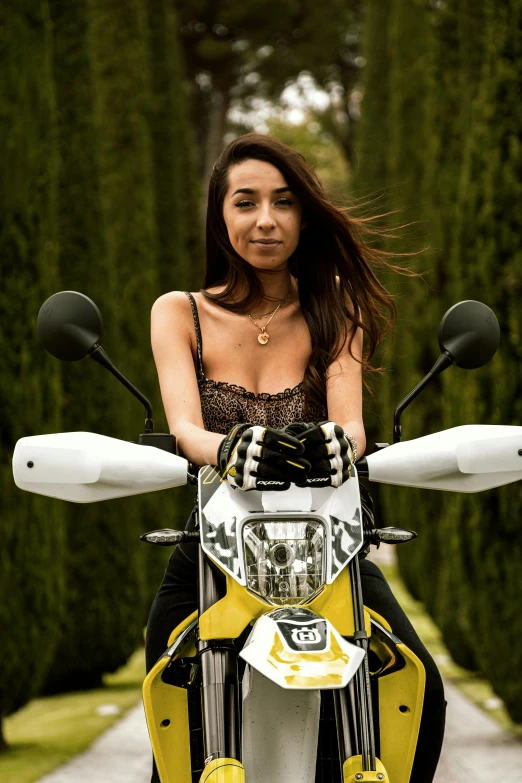 a woman sitting on a yellow and white motorcycle, pexels contest winner, photorealism, portrait of ana de armas, off-roading, furry arms, avatar image