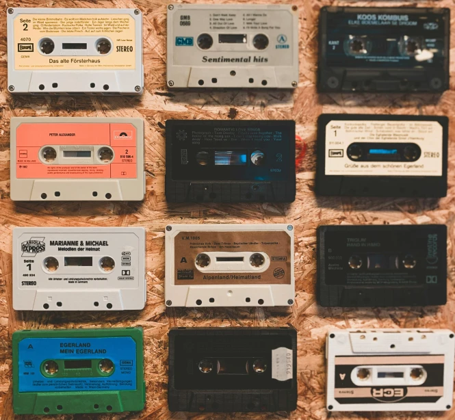 a bunch of cassettes sitting on top of a table, trending on pexels, instruments, vintage aesthetic, in a row, synthetic materials