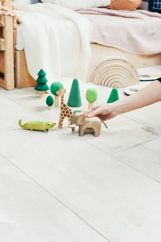 a woman playing with wooden toys in a child's room, pexels contest winner, stand on stone floor, jungle scene, detailed product image, super detail of each object