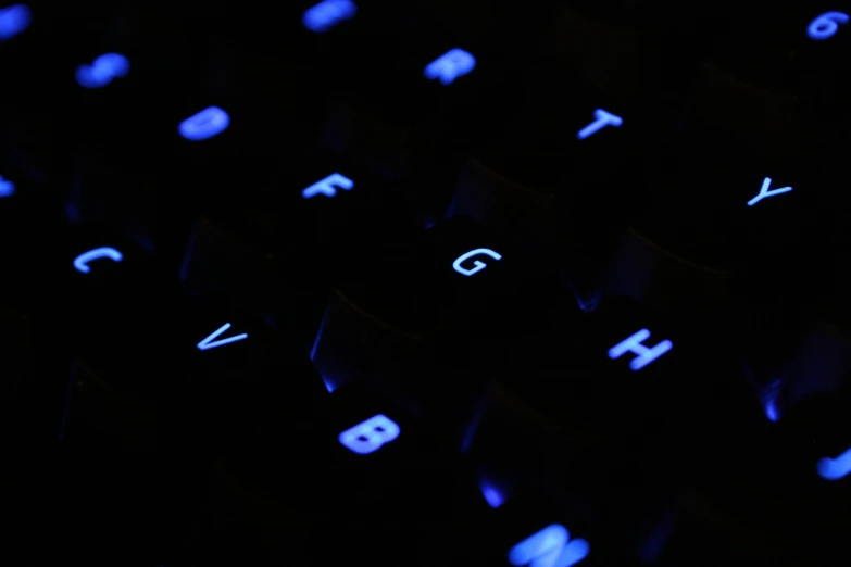 a close up of a keyboard in the dark, light blue skin, dark themed, avatar image, low-angle shot