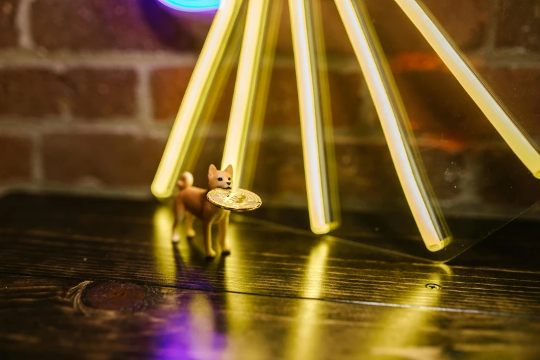 a cat figurine sitting on top of a wooden table, a hologram, pexels contest winner, kinetic art, neon standup bar, small dog, gold dappled lighting, detail shot