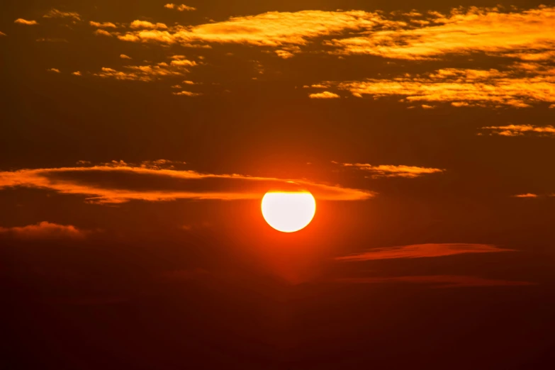 the sun is setting behind the clouds in the sky, by Matthew Smith, pexels, digital yellow red sun, hot and humid, wide, may 1 0