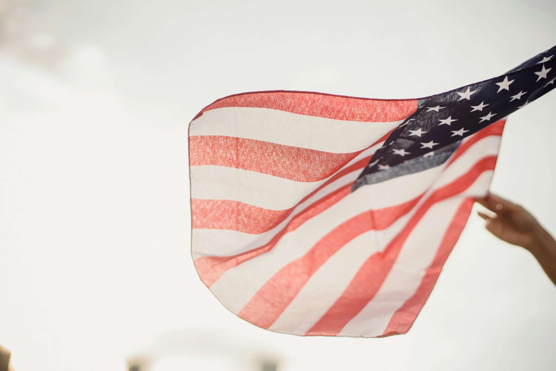 a person holding an american flag in the air, unsplash, white, digital image, close up image, instagram post