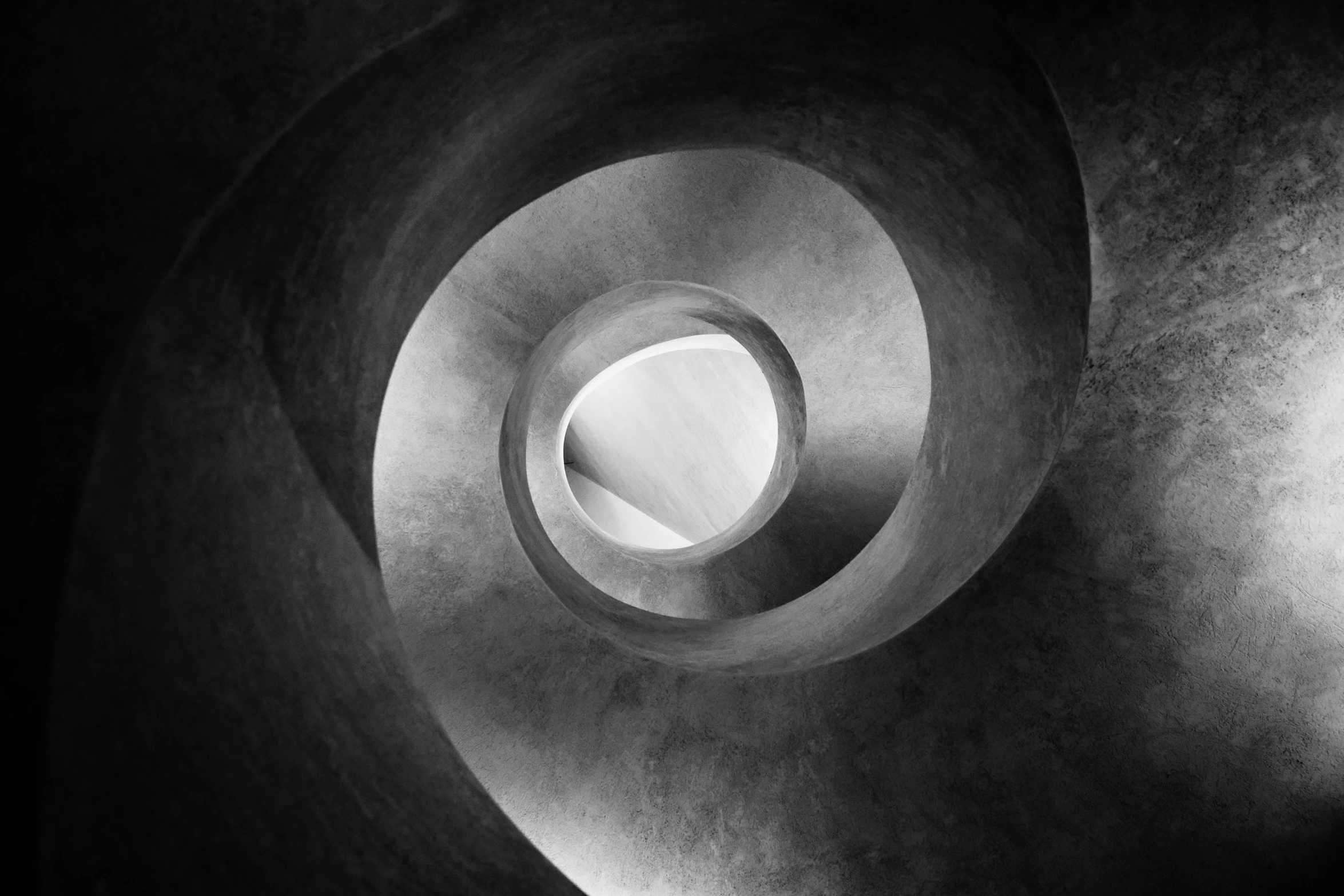 a black and white photo of a spiral staircase, an abstract sculpture, inspired by Edward Weston, unsplash contest winner, concrete art, inner glow, made of concrete, nonagon infinity, 4 0 mm