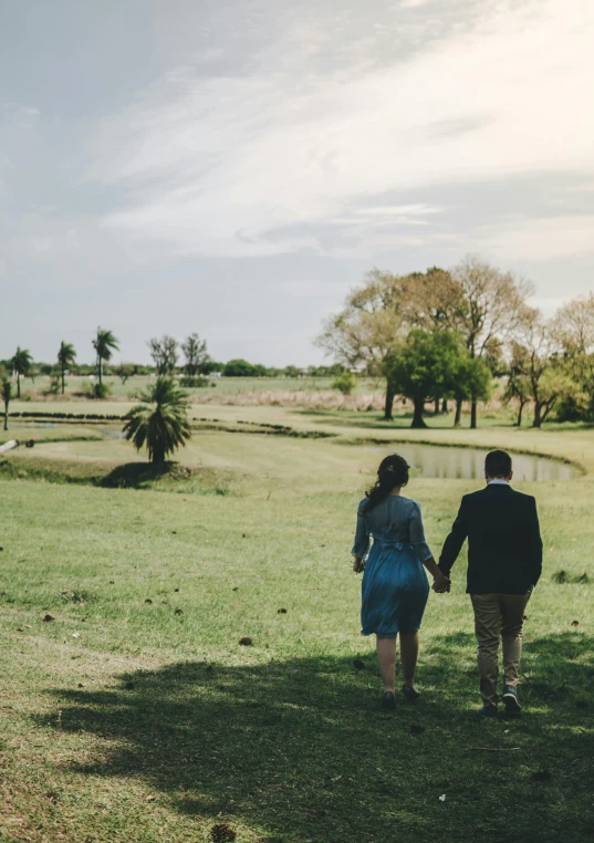 a couple of people walking across a lush green field, camilo gc, instagram picture, romantic, savanna