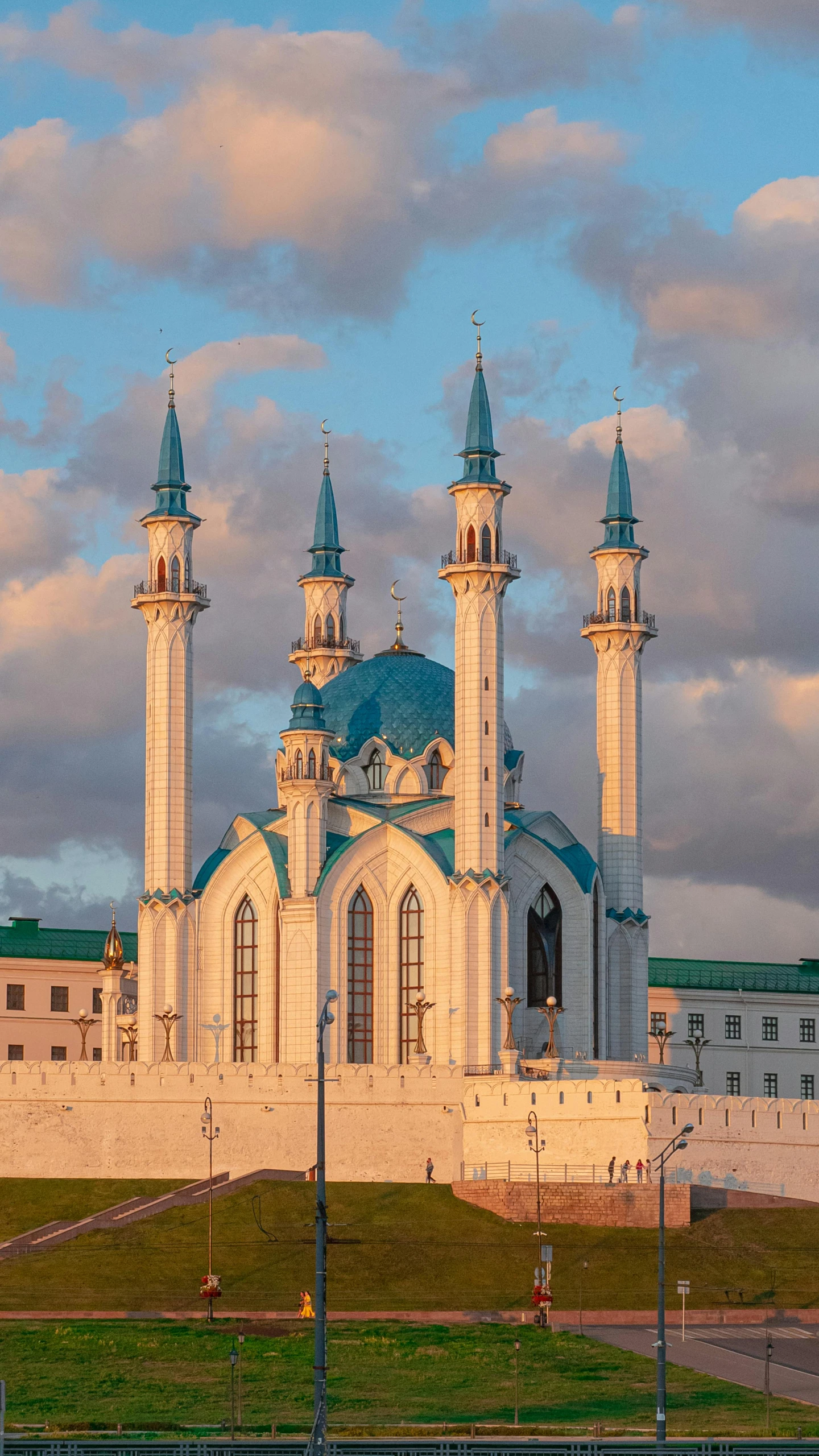 a large white building sitting on top of a lush green field, shutterstock, hurufiyya, gold and teal color scheme, minarets, 000 — википедия, square