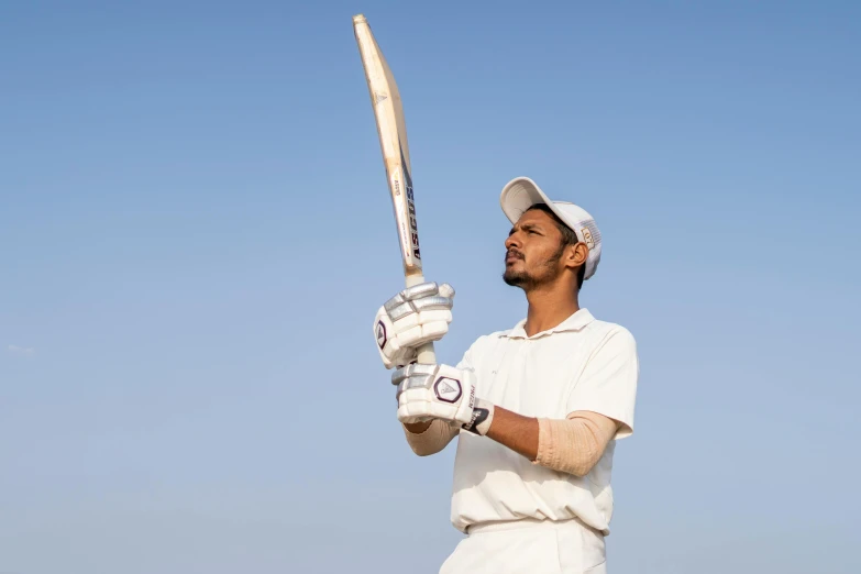 a man holding a bat on top of a field, a portrait, pexels contest winner, white uniform, profile image, vastayan, game ready