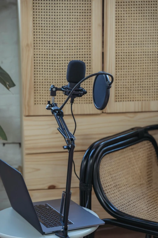 a laptop computer sitting on top of a desk next to a microphone, product image, experimental studio light, owl studio, panels