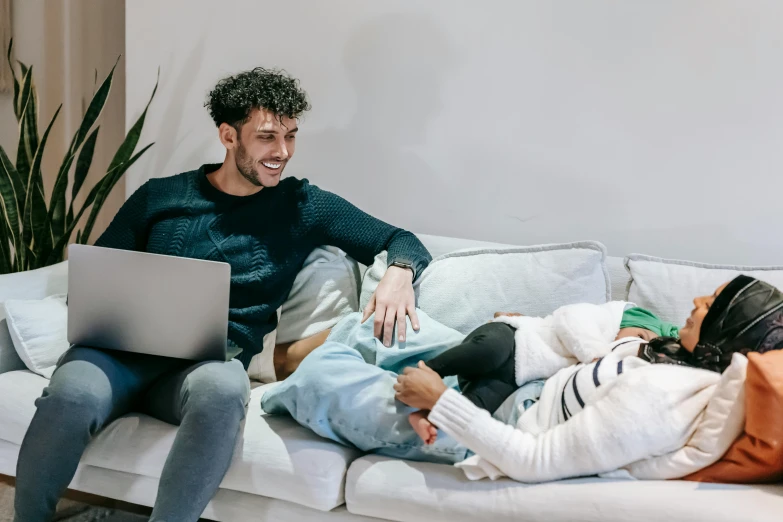 a man and a woman sitting on a couch with a laptop, pexels contest winner, two men hugging, lachlan bailey, healthcare, with a kid