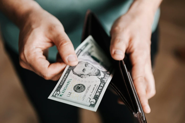 a person holding a wallet full of money, pexels contest winner, fan favorite, avatar image, carson ellis, usa-sep 20