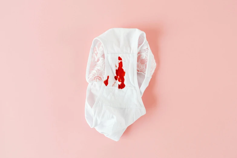 a disposable diaper on a pink background, by Ellen Gallagher, dada, in an apron covered in blood, white lace, design on a white background, bodysuit