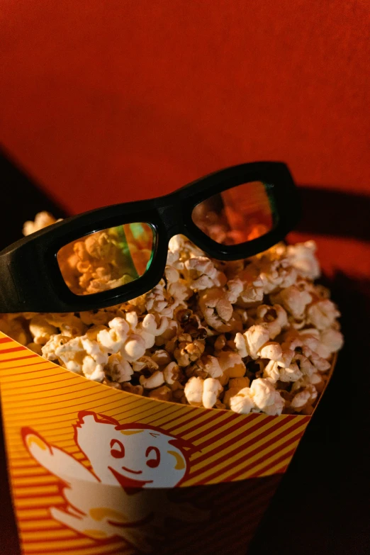 a cup of popcorn with a pair of glasses on top of it, holographic display lenses, taken in the 2000s, fan favorite, glasses |
