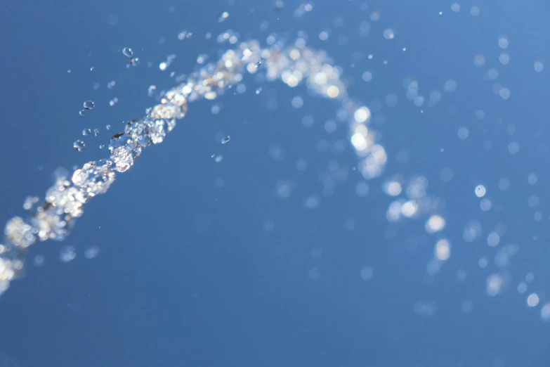 a close up of a sprinkle of water, inspired by Lucio Fontana, unsplash, sparkles sky, blender cycles render, rinko kawauchi, low angle shot