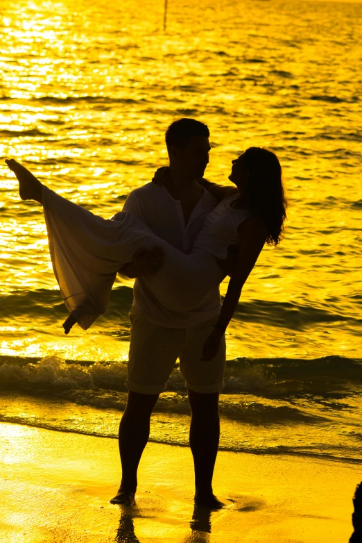 a man carrying a woman on the beach at sunset, slide show, uploaded, shades of yellow, romantic lead