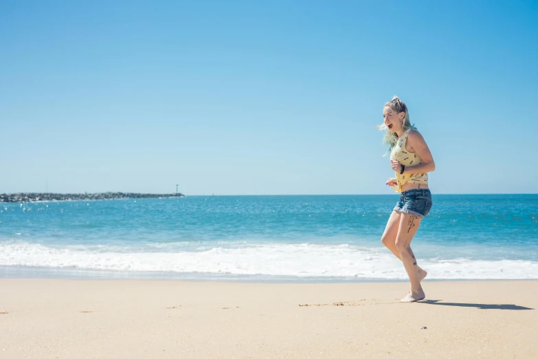 a woman running on a beach near the ocean, by Liza Donnelly, pexels contest winner, on a hot australian day, blonde, flowers around, santa monica beach