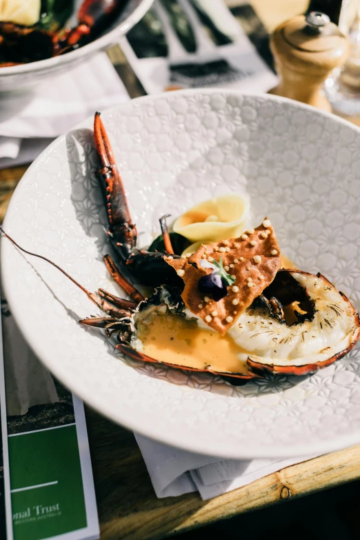 a close up of a plate of food on a table, by Lee Loughridge, unsplash, jordan peterson as a lobster, creamy, amber, australian