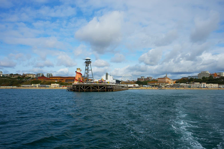 a lighthouse in the middle of a body of water, theme park, harbour in background, a crystal palace, 2022 photograph