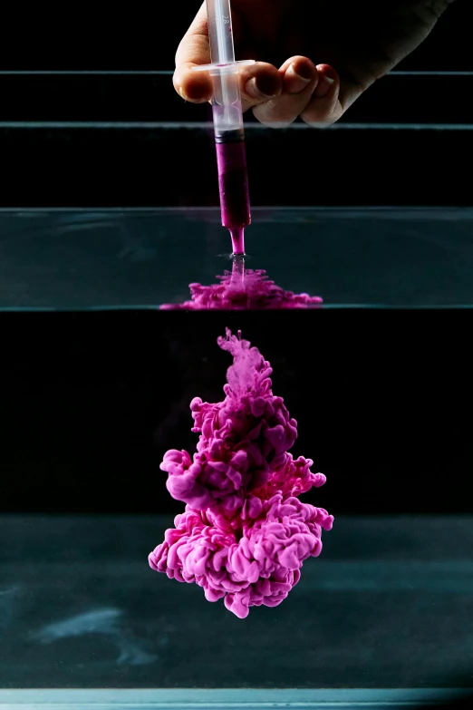 a person pouring liquid into a bowl of water, by Doug Ohlson, process art, featuring pink brains, thick pigmented smoke, molecular gastronomy, quinacridone magenta