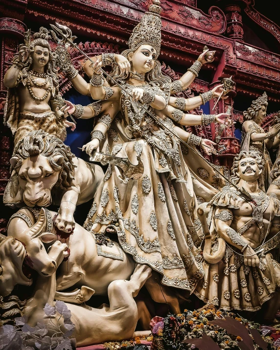 a statue of a woman surrounded by other statues, pexels contest winner, bengal school of art, intricate devilish designs, kali, standing triumphant and proud, ivory carving