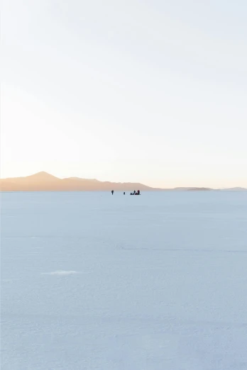 a group of people walking across a snow covered field, unsplash contest winner, minimalism, at salar de uyuni, sitting down, space ship in the distance, soft morning light