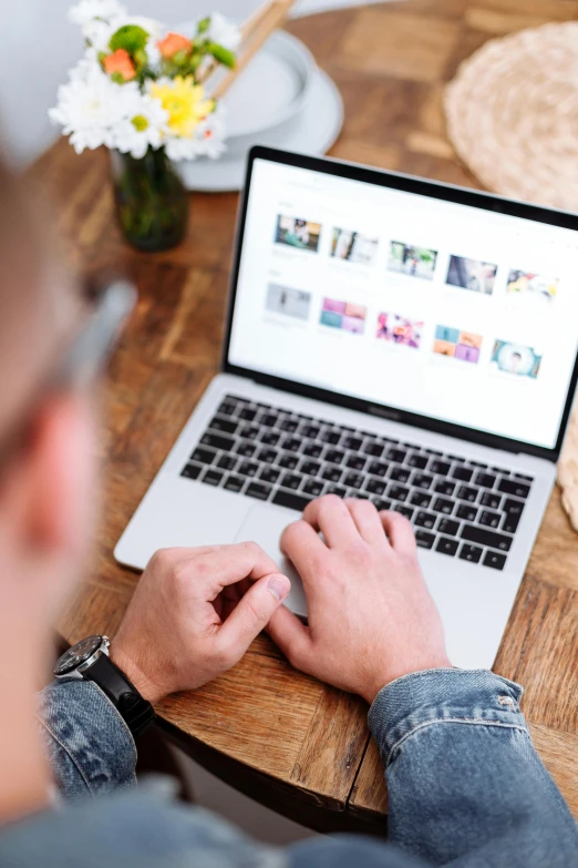 a man sitting at a table using a laptop computer, a picture, trending on pexels, happening, flatlay, digital banner, lots of pictures, official screenshot