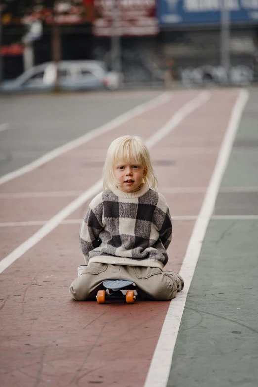 a little boy sitting on a skateboard on a tennis court, an album cover, by Ejnar Nielsen, unsplash, portrait of nordic girl, checkered floor, sweater, at racer track