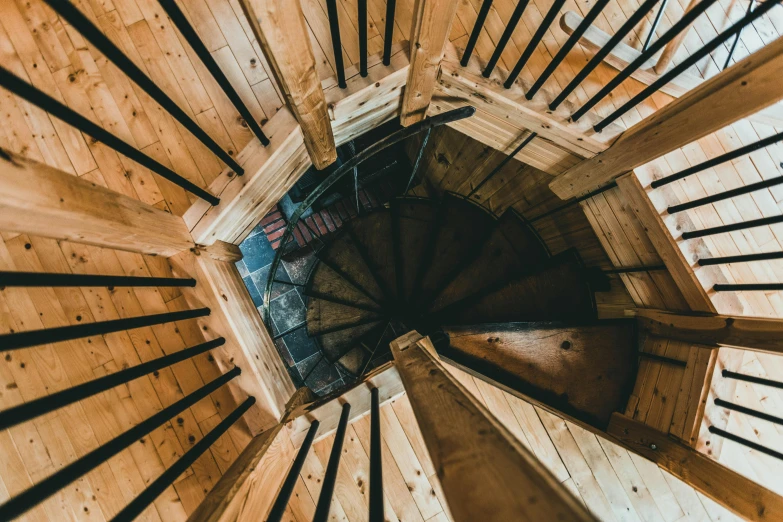 a spiral staircase inside of a wooden structure, by Emma Andijewska, pexels contest winner, 2 5 6 x 2 5 6 pixels, medieval cottage interior, high view, an escape room in a small