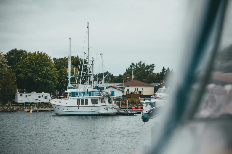 a couple of boats that are in the water, a portrait, unsplash, picton blue, astri lohne, seen from outside, dylan kowalsk