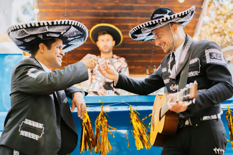 a couple of men standing next to each other, pexels contest winner, happening, wearing sombrero, battle toast, bells, aussie baristas