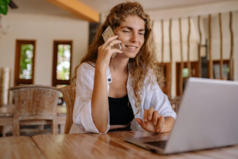 a woman sitting at a table talking on a cell phone, trending on pexels, renaissance, laptop, aussie, avatar image, blonde