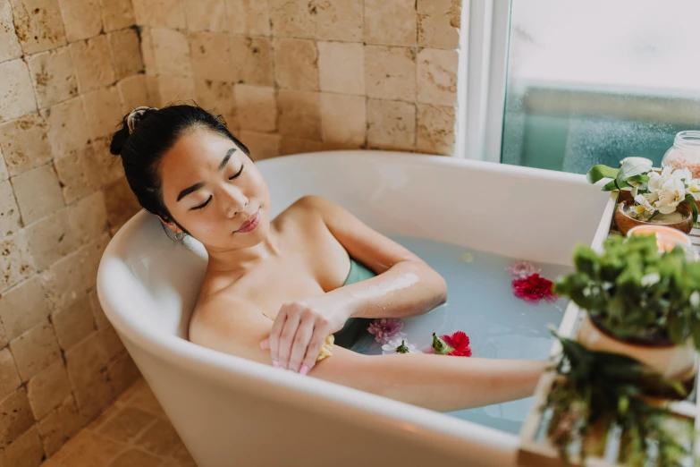 a woman taking a bath in a bathtub, unsplash, vietnamese woman, fan favorite, manuka, candy treatments