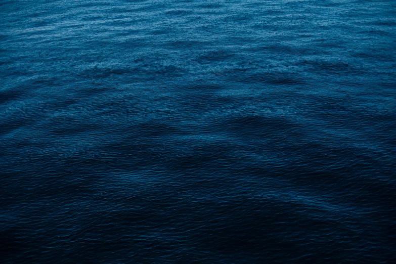 a boat floating on top of a large body of water, by Elsa Bleda, unsplash, minimalism, dark blue skin, ((waves, mobile wallpaper, highly detailed image