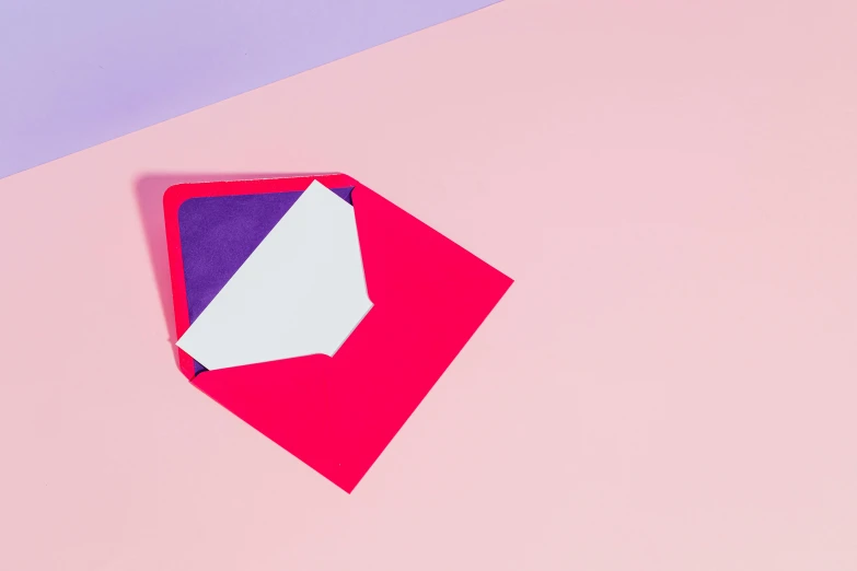 a piece of paper sitting on top of a pink and blue surface, by Julia Pishtar, trending on unsplash, letterism, red and purple, delivering mail, angular minimalism, email