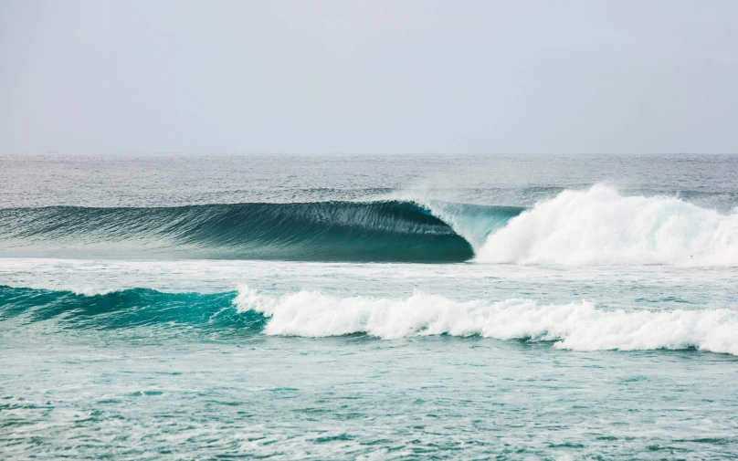 a man riding a wave on top of a surfboard, by Peter Churcher, pexels contest winner, hurufiyya, reefs, lined up horizontally, o'neill cylinder, photograph of april