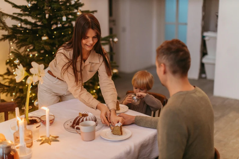 a couple of people that are sitting at a table, christmas, profile image, cake in hand, serving suggestion