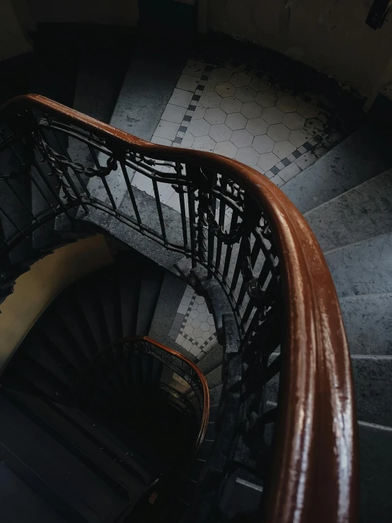 a close up of a spiral staircase in a building, pexels contest winner, art nouveau, slate, low quality photo, brown, overlooking