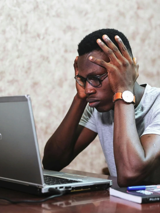 a man sitting in front of a laptop computer, by Chinwe Chukwuogo-Roy, pexels, renaissance, upset, lgbt, 15081959 21121991 01012000 4k