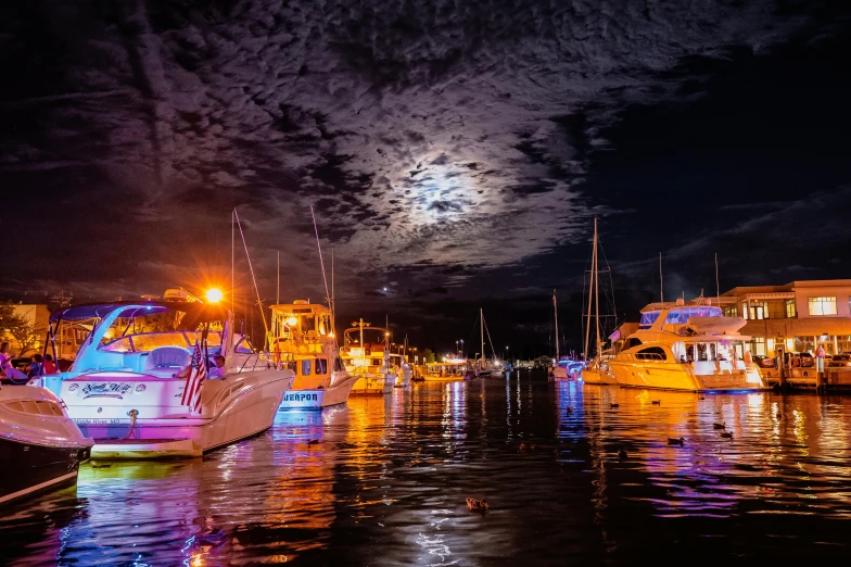 a group of boats sitting on top of a body of water, by Lee Loughridge, pexels contest winner, moon glow, manly, vivid and detailed, thumbnail